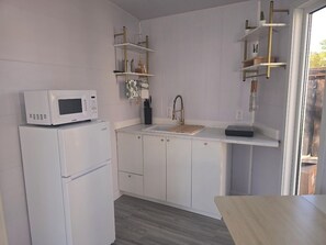 Fridge, microwave, coffee/tea maker, cookware/dishes/utensils