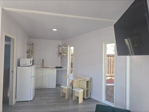 Fridge, microwave, coffee/tea maker, cookware/dishes/utensils