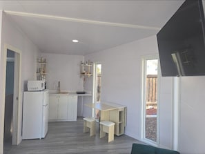 Fridge, microwave, coffee/tea maker, cookware/dishes/utensils