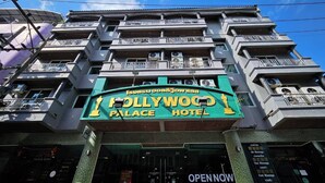 A multi-story hotel with balconies and air conditioning units. - Hollywood Dannok Hotel (Sadao)
