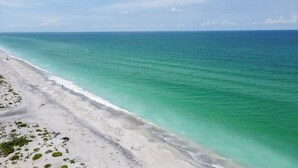 A beach with clear turquoise water and white sand.