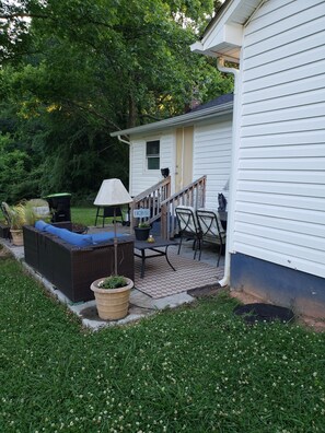 A house with a porch, outdoor furniture, and a garden. - Charming 2-bedroom vintage cottage with WiFi, a/c, and other popular amenities. (Salisbury)