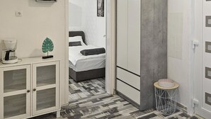 A bedroom with a bed, a wardrobe, a small cabinet, and a coffee maker. - Prskalo by Interhome (Omiš)