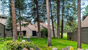 A residential area with numbered wooden posts, a pathway, and houses with sloped roofs. - Recently Remodeled Golf Course Condo w/ A/C, SHARC Passes, Bikes & Pet Friendly (Sunriver)