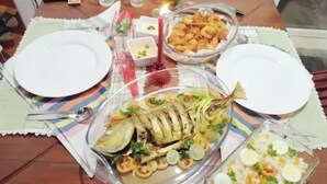 A dining table set with plates, a glass bowl of fried food, a glass dish with rice and shrimp, and a glass bowl of fish. - Jennifers Villa, Make your soul full in Love and Peace in Negombo AC,Wifi,Beach (Negombo)