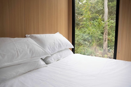 1 bedroom, bed sheets. Rocky Creek Escape by Tiny Away