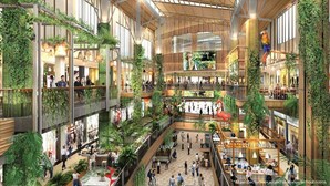 A multi-level shopping mall with indoor plants, a coffee ground, and a tropical oasis advertisement. - NJoy Boutique Guesthouse (Patong)