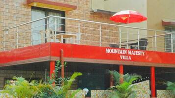 A building with a red facade and the name "MOUNTAIN MAJESTY VILLA" prominently displayed.