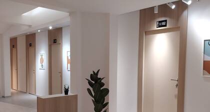 Private room 8m for men. Bed, AC, side table, Wi-Fi. Shared baths, lounges.