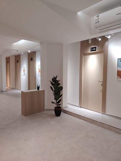 Private room 8m for men. Bed, AC, side table, Wi-Fi. Shared baths, lounges.