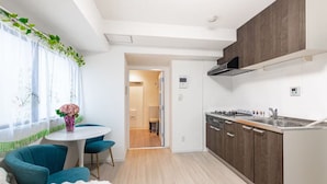 A modern kitchen with wooden cabinets, a built-in oven, and a stainless steel sink. - New Ueno Station 7 Min Walk Inarimachi (Tokyo)