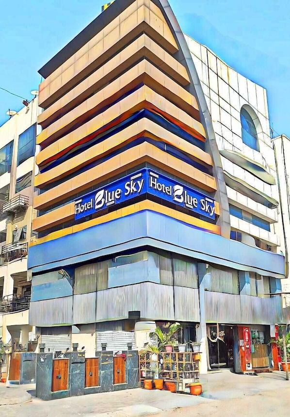 A modern hotel with a distinctive angular design, featuring multiple balconies and a prominent 'Hotel Blue Sky' sign. - HOTEL BLUE SKY (Ahmedabad)
