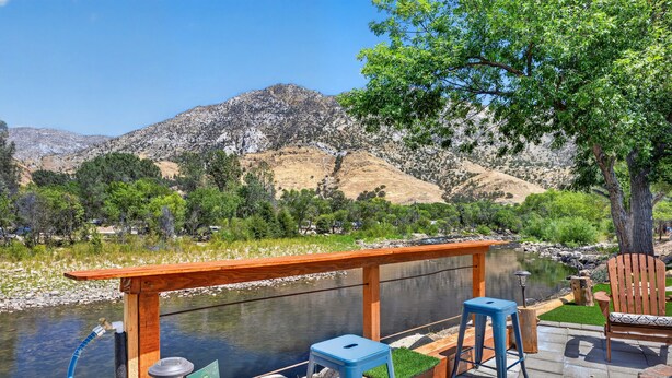 A wooden deck with a view of a river and mountains. - Waterfront,  family resort, 2 separate units, Sauna, and Jacuzzi/ sleeps 8 (Kernville)