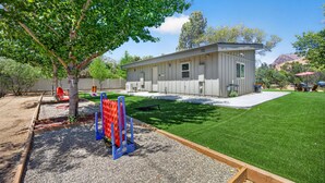 A modern building with a flat roof, a small porch, and a well-maintained lawn. - Waterfront,  family resort, 2 separate units, Sauna, and Jacuzzi/ sleeps 8 (Kernville)