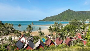 A beach resort with traditional architecture, a swimming pool, and a view of the sea and mountains. - Chaloklum Residences by Kupu Kupu Phangan (Ko Pha-ngan)
