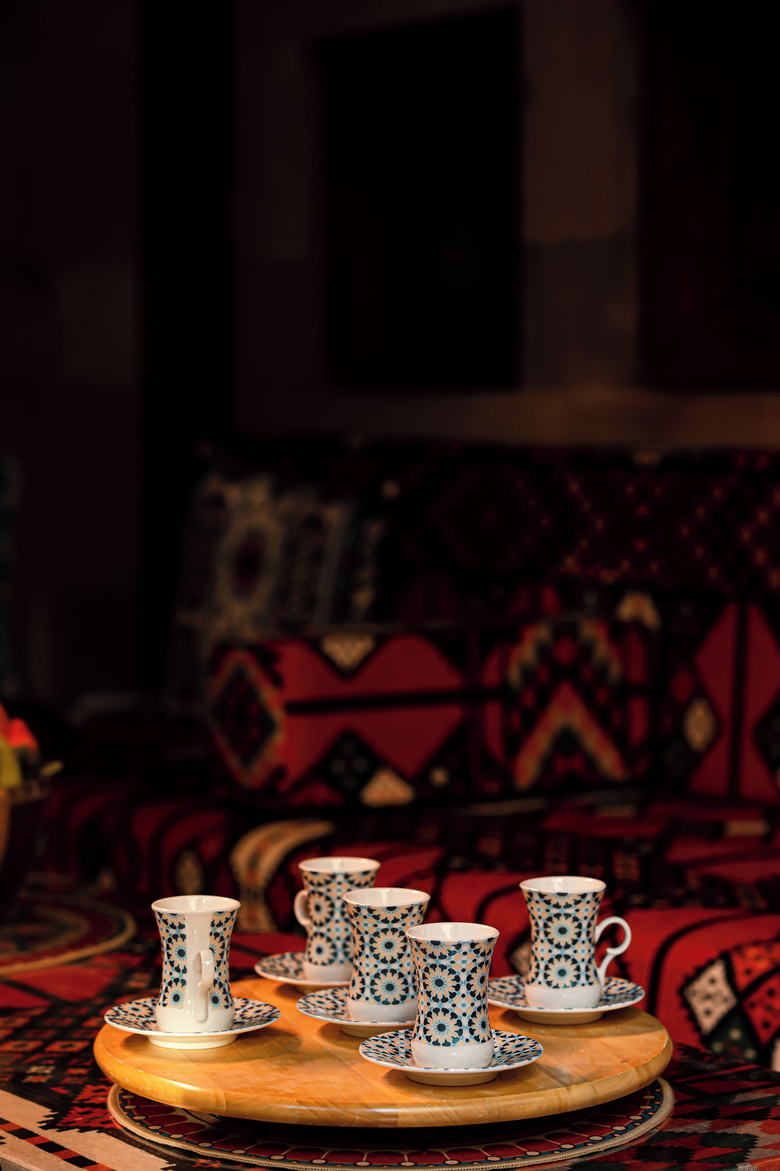 A tray with four cups and saucers on a table.