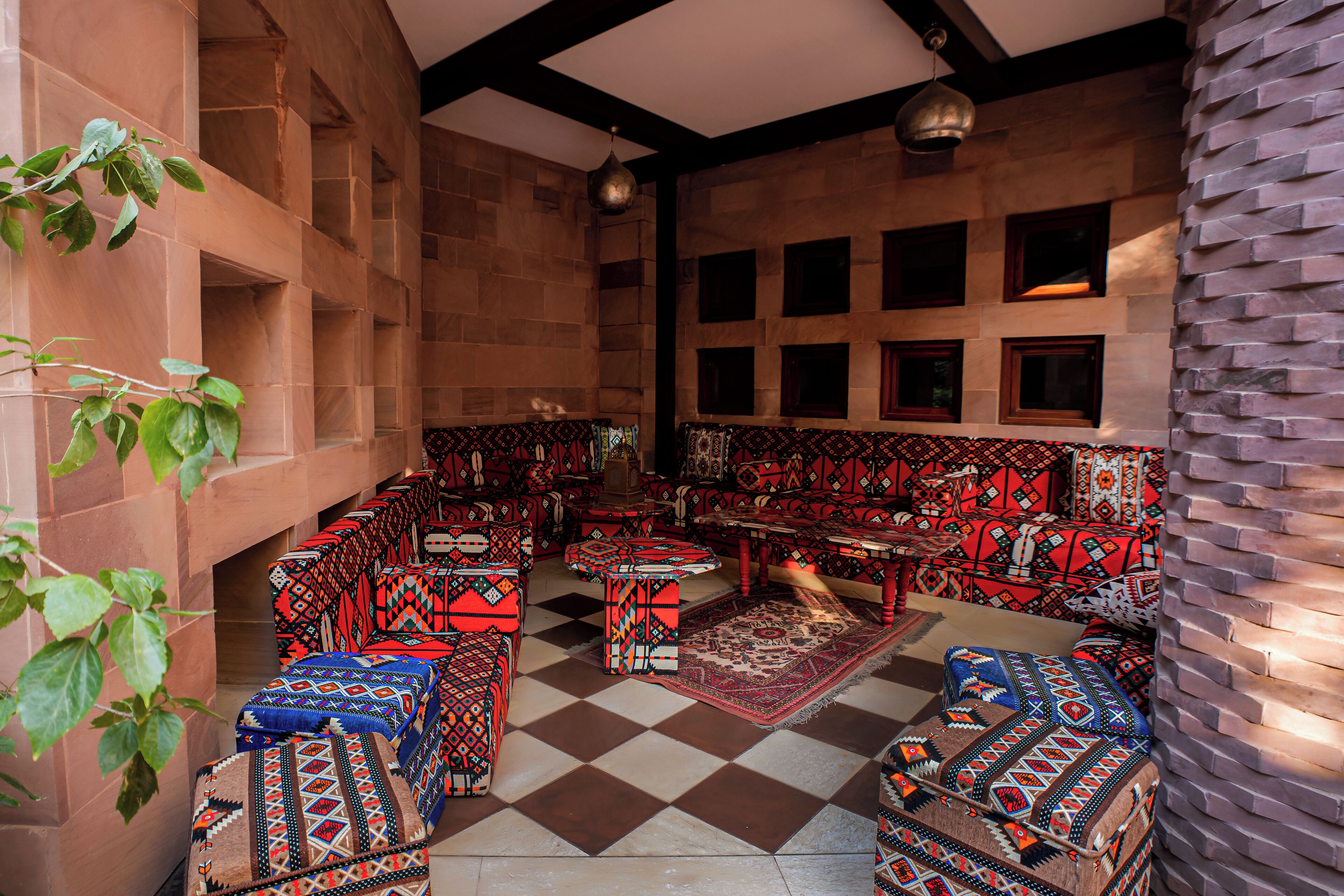 A traditional interior with patterned furniture and a checkered floor.