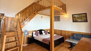 A wooden interior with a staircase, a bed, a sofa, and a table. - Shri Shail Inn (Dhari)