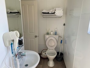 Shower, hair dryer, towels, toilet paper