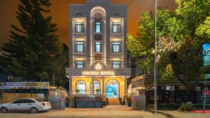 The Orchid Hotel with a modern facade, multiple windows, and a signboard. - ORCHID Hotel (Lam Vien - Da Lat)