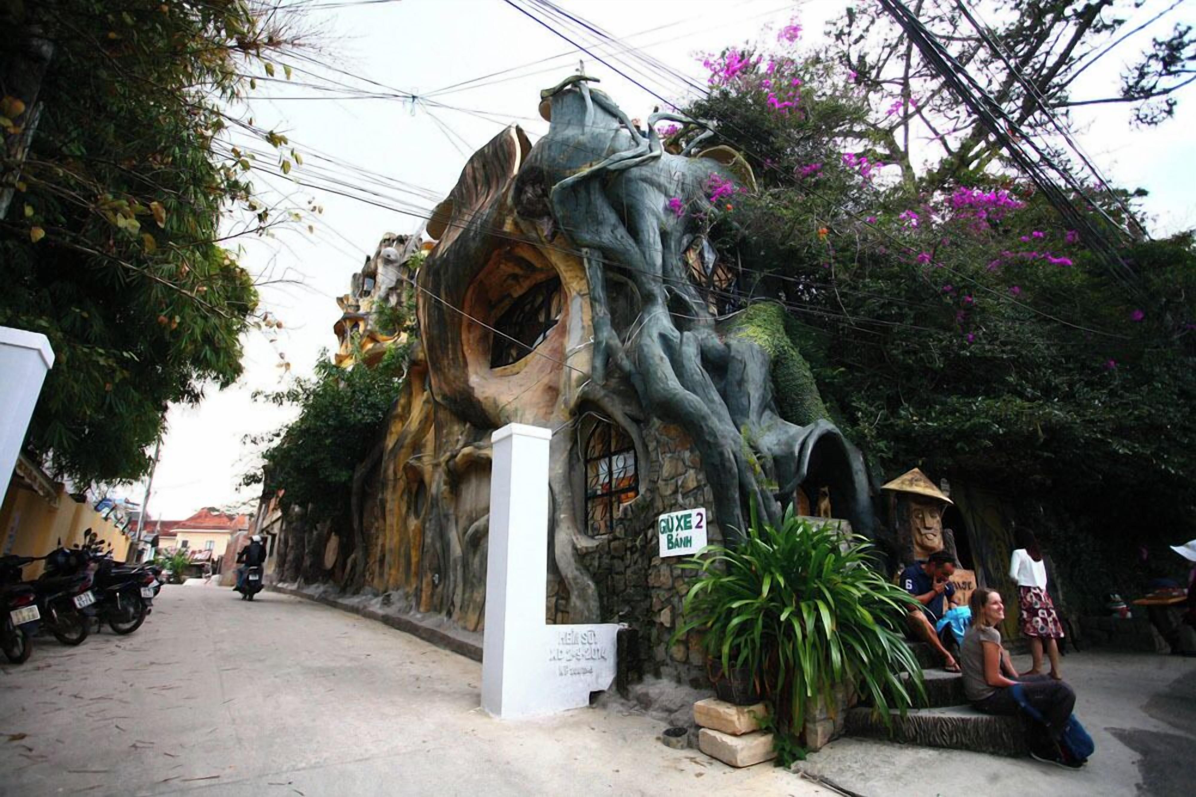 A unique treehouse-like structure with a sign reading "GUXE 2 Banh".