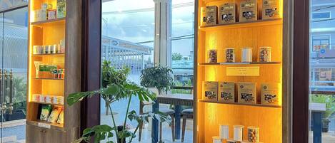 A display of packaged goods in a store with wooden shelves and a large window.