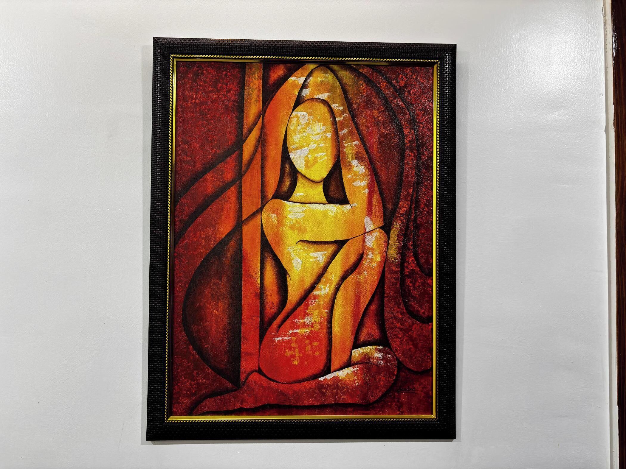 Une peinture abstraite encadrée, caractérisée par une composition géométrique.