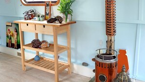 A room with a wooden desk, a window with a view, a wall-mounted radiator, and a small plant. - 5 Star Stunning Houseboat, no Experience Required! Enjoy the Most Romantic Trip! (Monasterevin)