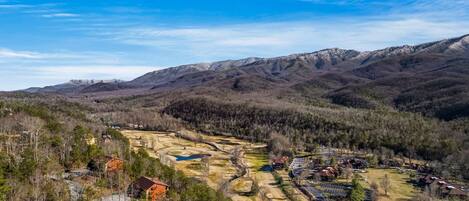 A mountainous landscape with residential areas and a clear sky.