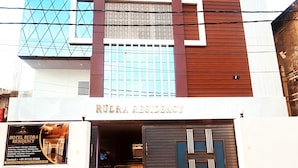 A hotel named 'Rudra Residency' with a modern facade featuring a mix of glass and wood paneling. - HOTEL RUDRA RESIDENCY (Patna)