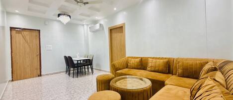 Luxury Suite, Balcony, Garden View | Living area | TV