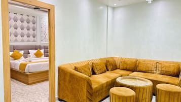 Luxury Suite, Balcony, Garden View | Living area | TV