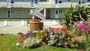 A residential building with a staircase leading to a balcony. - Beachfront apartment with direct beach access! (Perranporth)