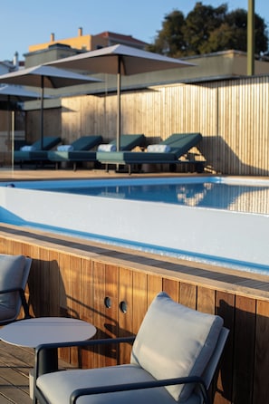 Seasonal outdoor pool, open 11:00 AM to 10:00 PM, pool umbrellas