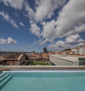 Seasonal outdoor pool, open 11:00 AM to 10:00 PM, pool umbrellas