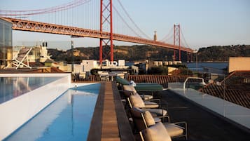 Seasonal outdoor pool, open 11:00 AM to 10:00 PM, pool umbrellas