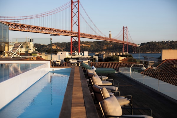 Seasonal outdoor pool, open 11:00 AM to 10:00 PM, pool umbrellas
