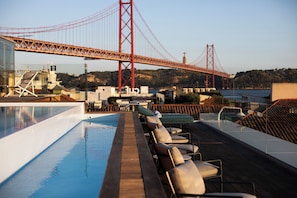 Seasonal outdoor pool, open 11:00 AM to 10:00 PM, pool umbrellas