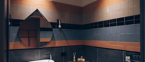 A modern bathroom with a sink, bidet, and mirror.