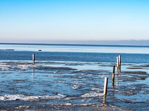 A coastal scene with a clear sky, calm sea, and several vertical poles in the foreground. - Stunning  villa for 4 people with WIFI, TV and terrace (Norden)