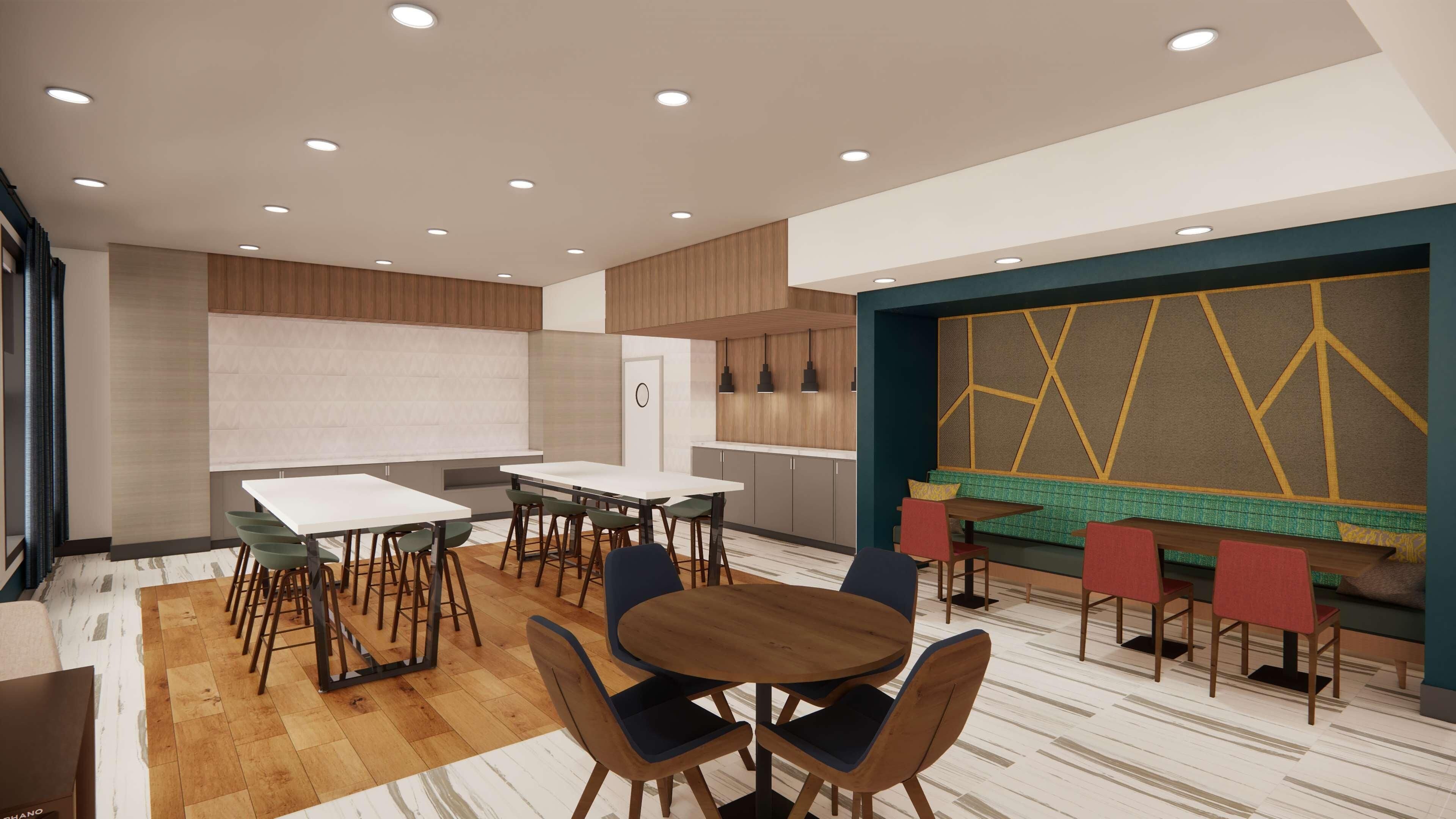 A modern dining area with multiple tables and chairs, a kitchen area with wooden cabinets, and a patterned wall with geometric designs.