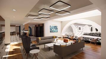 A modern interior with a dining area, a living room with sofas and coffee tables, and a large arched window providing natural light.
