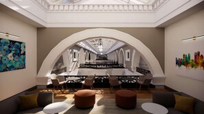 A modern conference room with a high ceiling, arched ceiling design, and a central table surrounded by chairs.