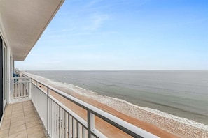A balcony with a view of the ocean.