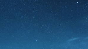 A desert campsite with tents under a starry night sky. - Magic Camps Wahiba Sands (Bidiya)