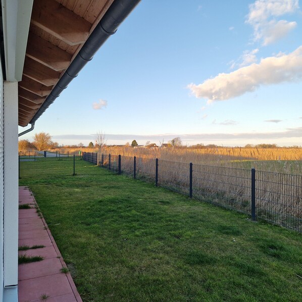 Enjoy a serene outdoor space with a well-maintained lawn and fence.