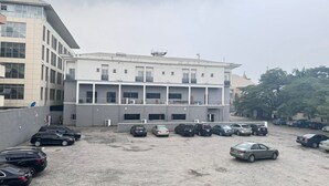 A multi-story parking garage with several cars parked. - Novatel Hotel (Lekki)