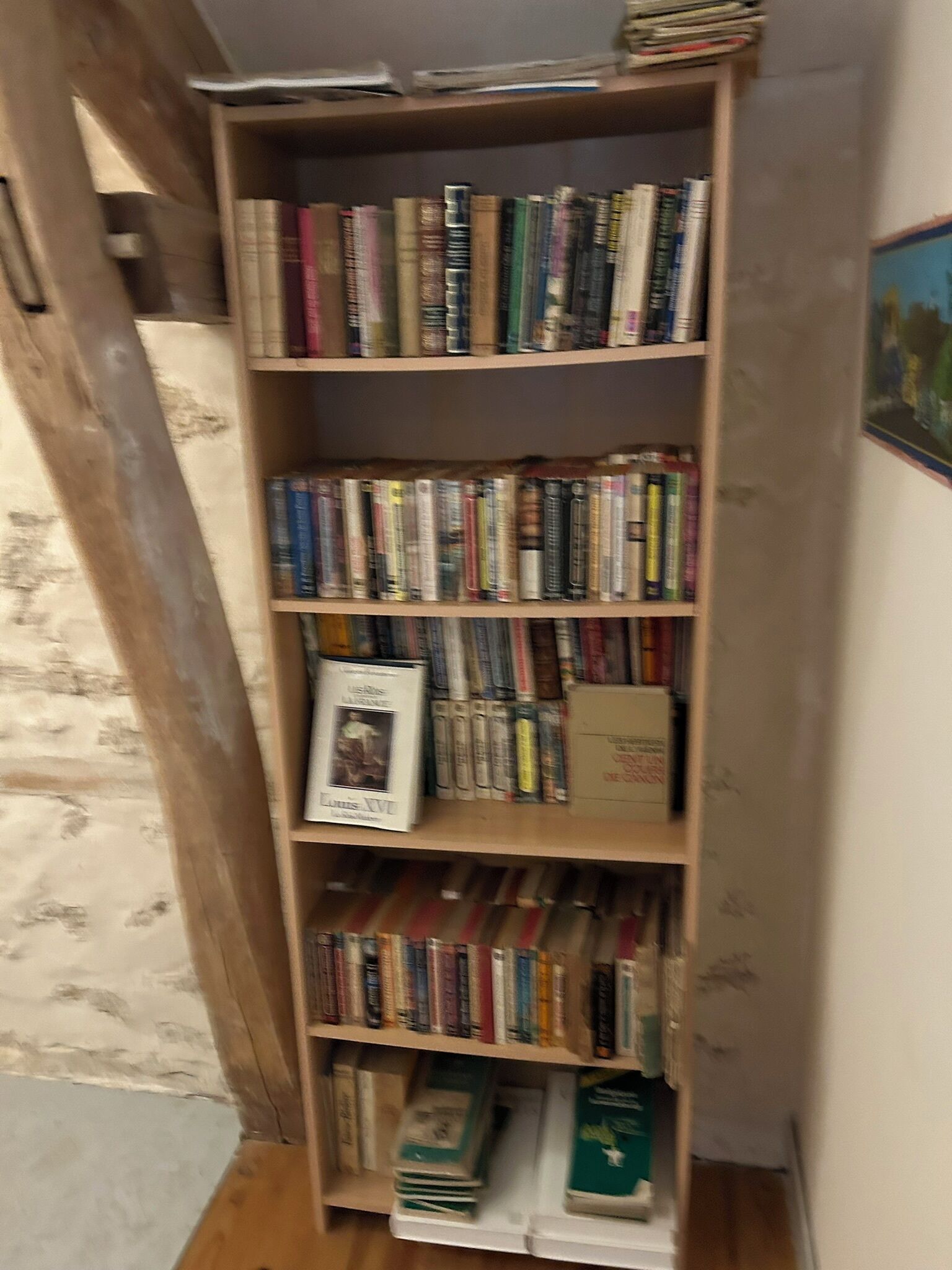 A bookshelf filled with books and magazines.