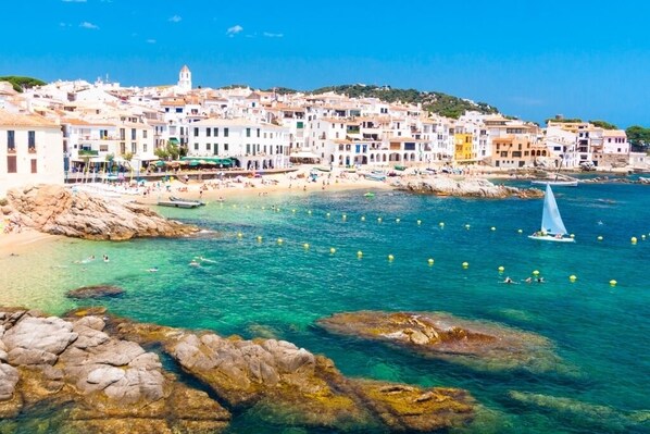 Stunning coastal town with Mediterranean-style buildings along the shoreline, offering access to the beach and water activities.