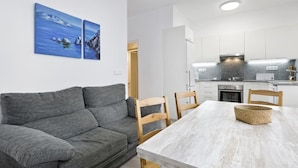 A modern kitchen with white cabinets, a built-in oven, and a granite countertop. - Blanch in Llafranc With 5 Bedrooms and 2 Bathrooms (Palafrugell)